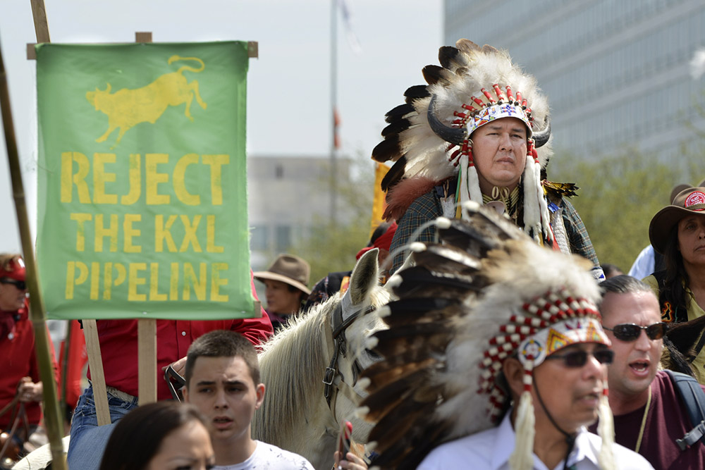 Members of the Cowboy and Indian Alliance ride horses and march down Independence Avenue as a coalition of ranchers, farmers and native American tribes begins a multi-day protest against  the Keystone XL pipeline on the National Mall.